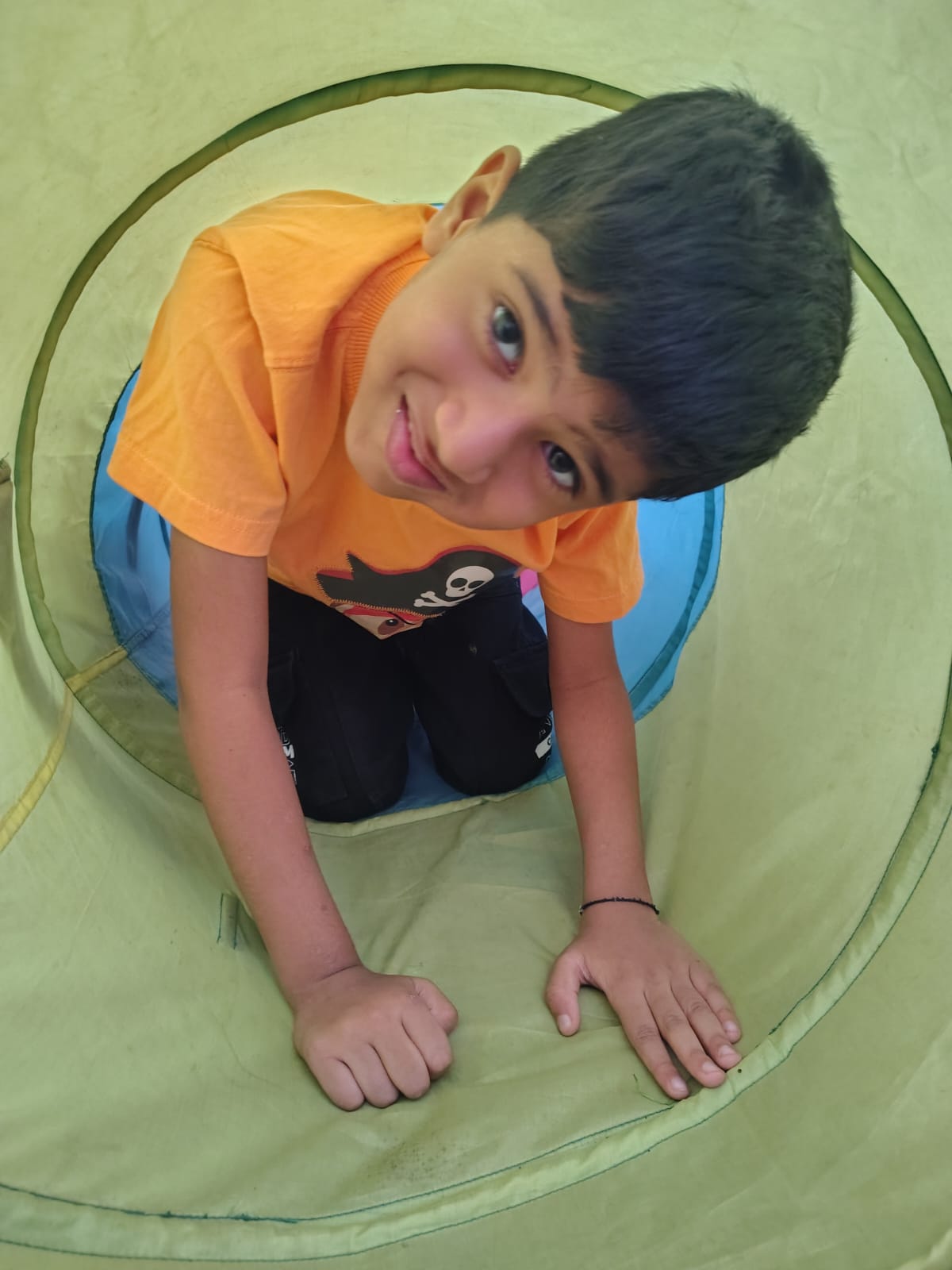 Child exploring a sensory play tunnel at the Aavishkaar centre